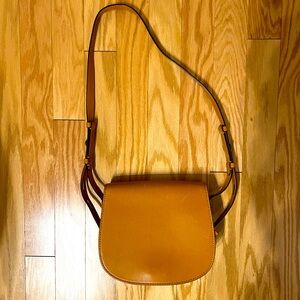 Excellent condition. Tan, Tory Burch cross-body saddle bag.